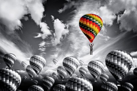 Businessman leader rising in a hot air balloon - Leadership concept